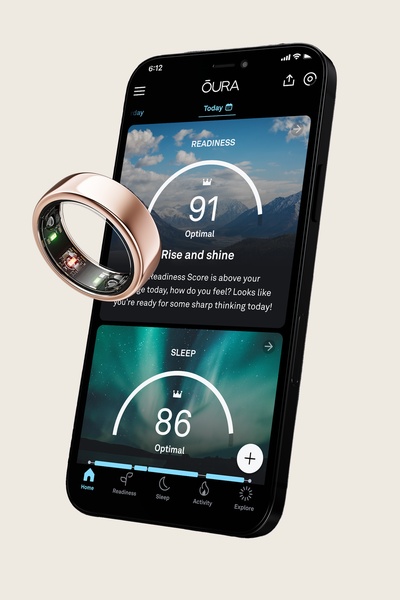 A high-quality product shot of a smart ring floating next to a smartphone screen displaying detailed health readiness scores and sleep analytics.